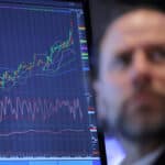 A trader works on the trading floor at the New York Stock Exchange (NYSE) in New York City