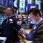 Traders work on the trading floor at the New York Stock Exchange (NYSE) in New York City