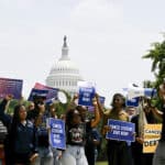 Demonstrators calling for the canceling of student debt march from the U.S. Capitol to the White House in Washington, June 30, 2023. (Kenny Holston/The New York Times)