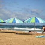 Visitors on a beach in the Condado neighborhood of San Juan, Puerto Rico, on March 28, 2024. (Scott McIntyre/The New York Times)